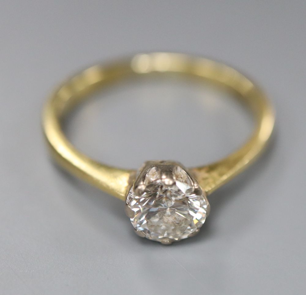 A modern 18ct gold and solitaire diamond ring, size M, gross 2.9 grams,